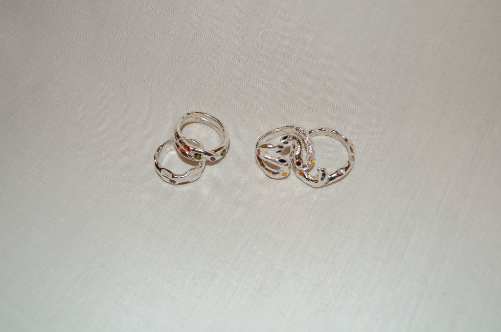 Pair of silver rings on a light fabric background