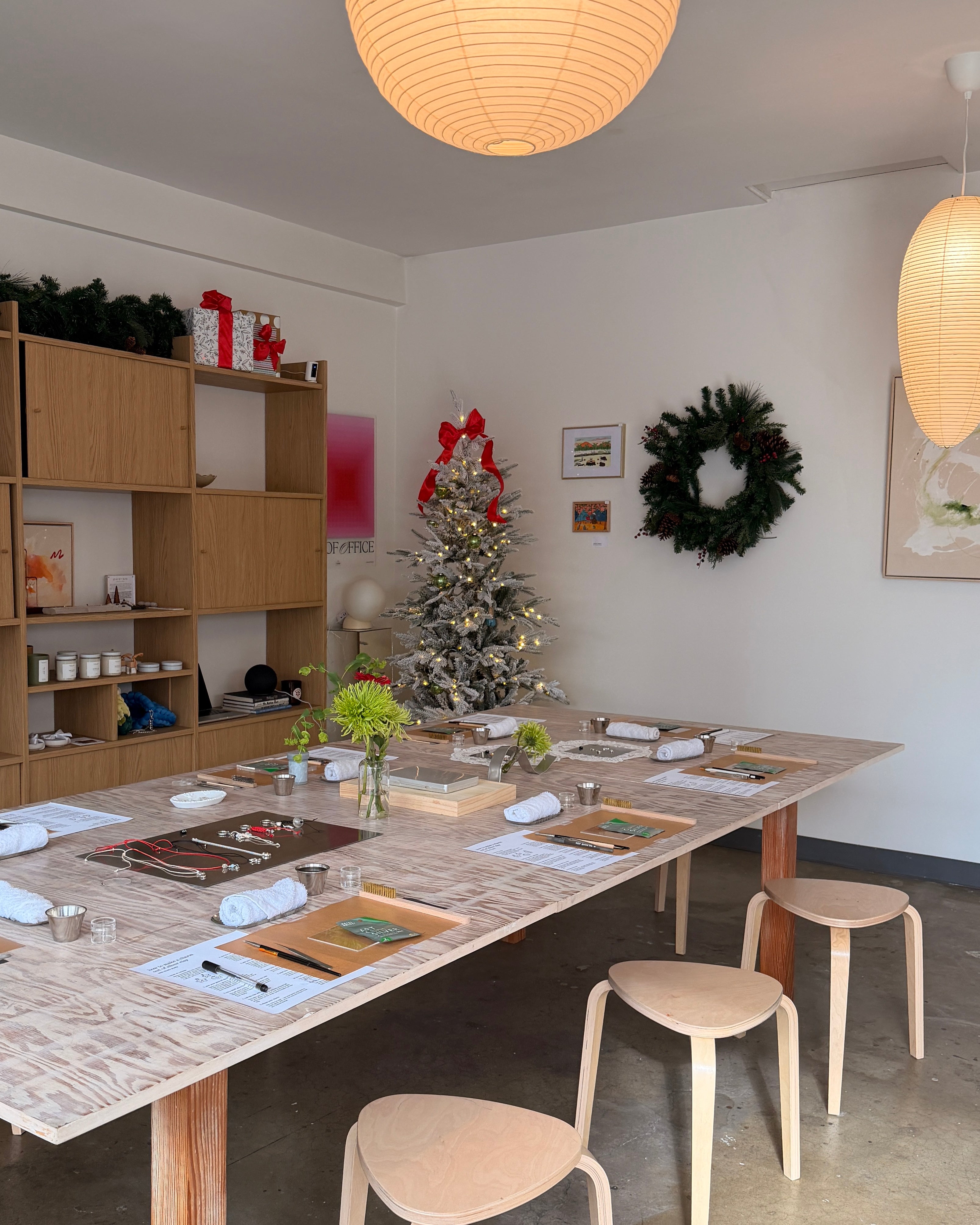 Room with a long table set for crafting silver clay rings.