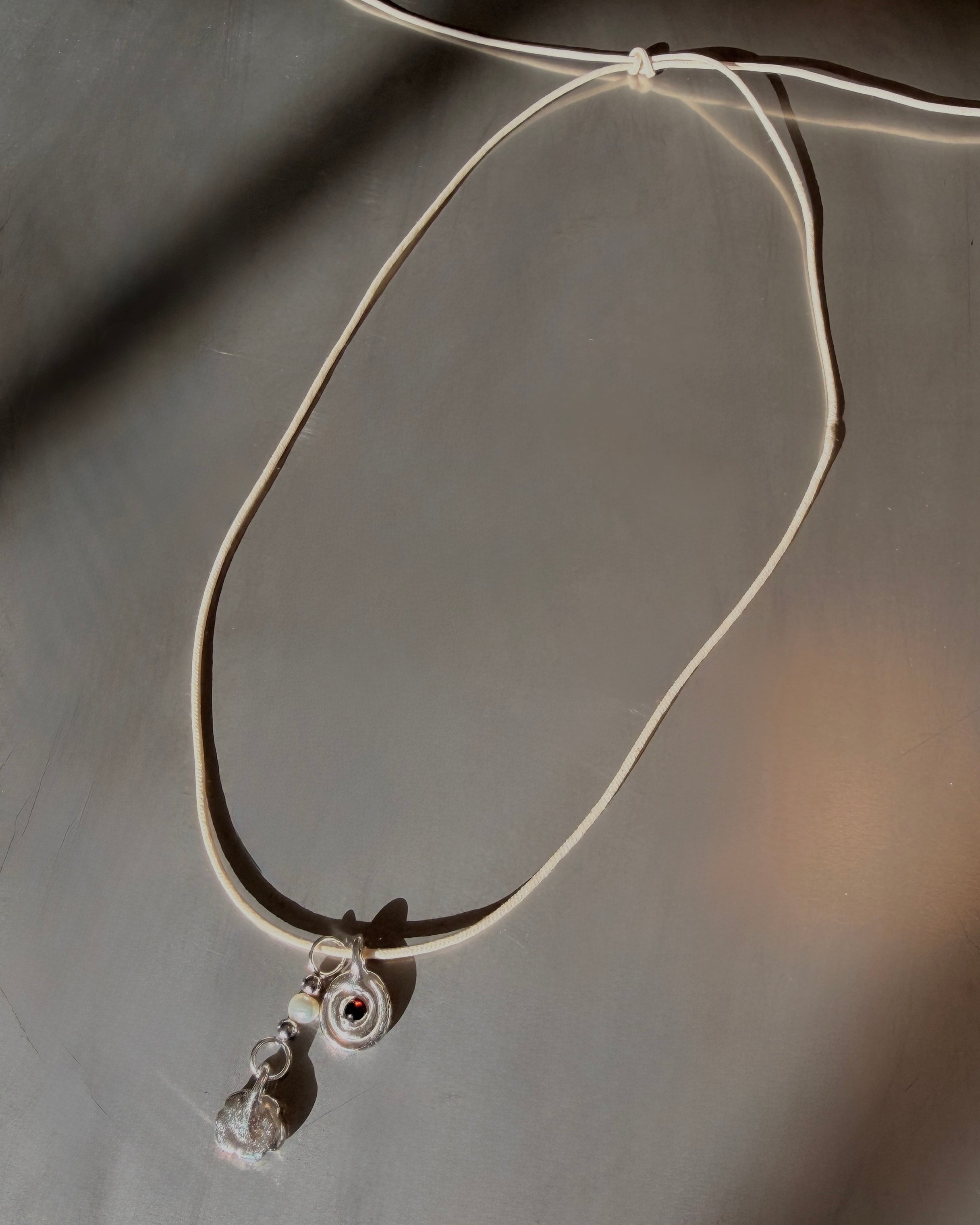Necklace with a pendant on a gray background